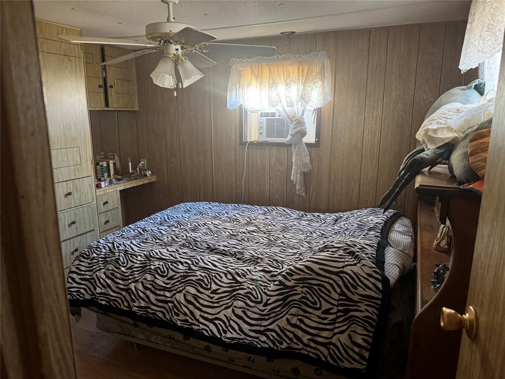 217 Buffalo Comanche, TX 76442 - Photo 11 of 13 a bedroom with a bed and a chandelier