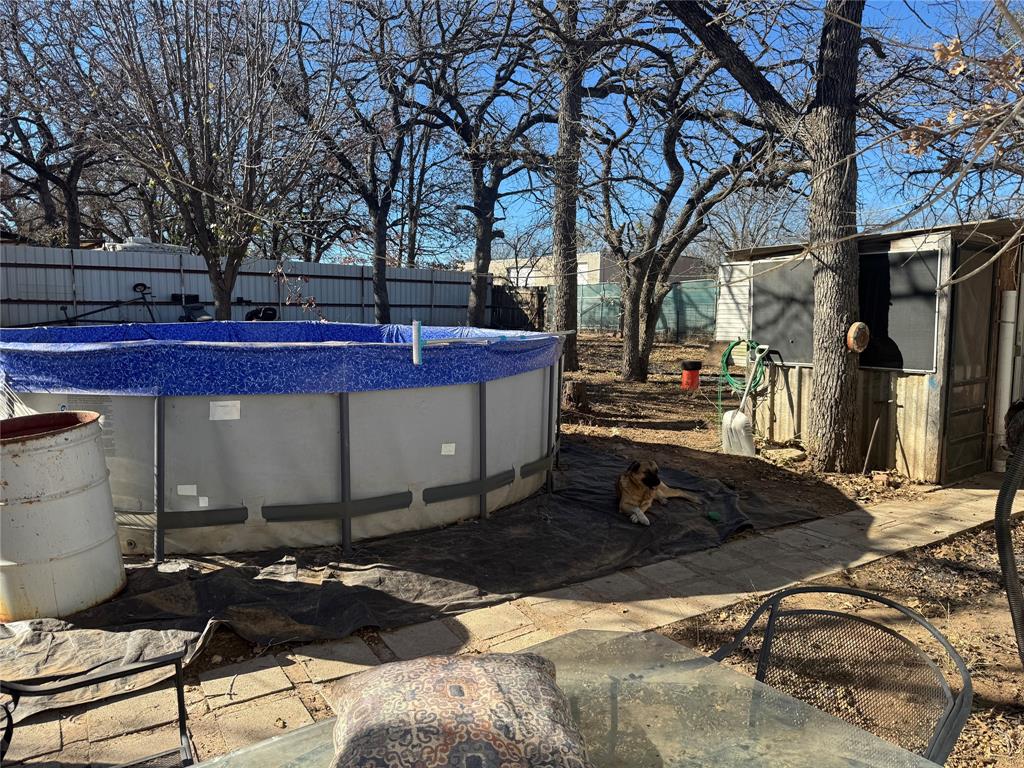 217 Buffalo Comanche, TX 76442 - Photo 12 of 13 a view of a chairs and table in backyard