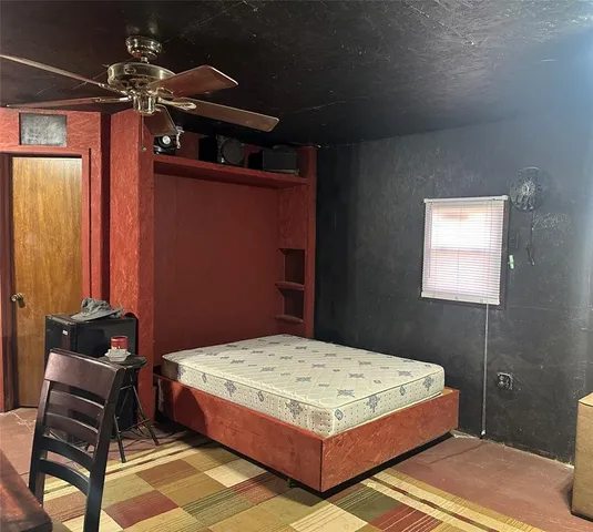 a bedroom with a bed and a chair