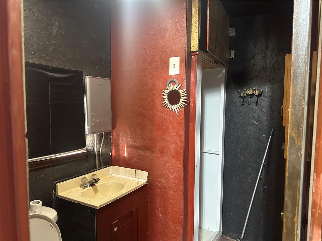 217 Buffalo Comanche, TX 76442 - Photo 6 of 13 a bathroom with a sink toilet and shower