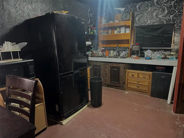 a kitchen with stainless steel appliances a refrigerator and a stove
