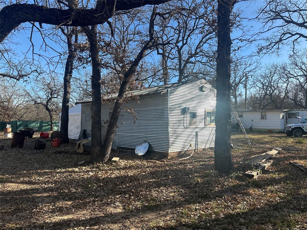217 Buffalo Comanche, TX 76442 - Photo 8 of 13 a view of a house with a yard