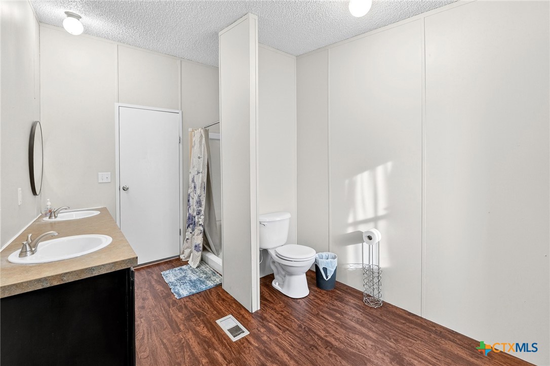 11213 Ridgewood Drive Salado, TX 76571 - Photo 15 of 24 a bathroom with a sink toilet a shower and a mirror