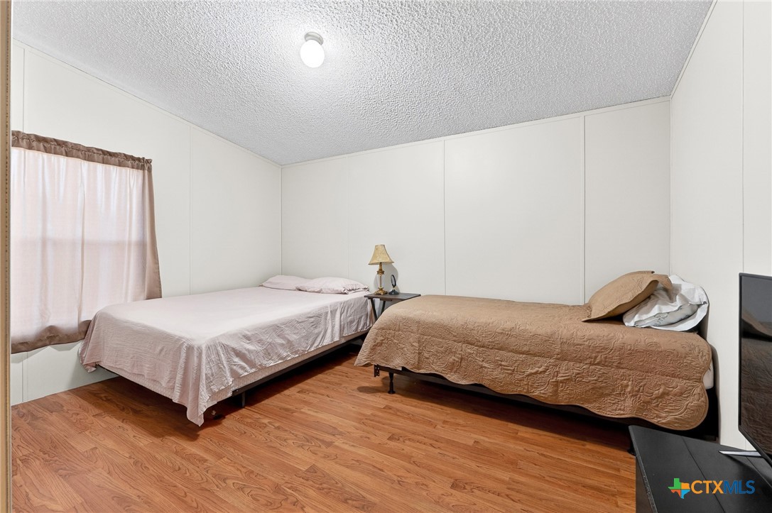 11213 Ridgewood Drive Salado, TX 76571 - Photo 19 of 24 a bedroom with two beds and painting on the wall