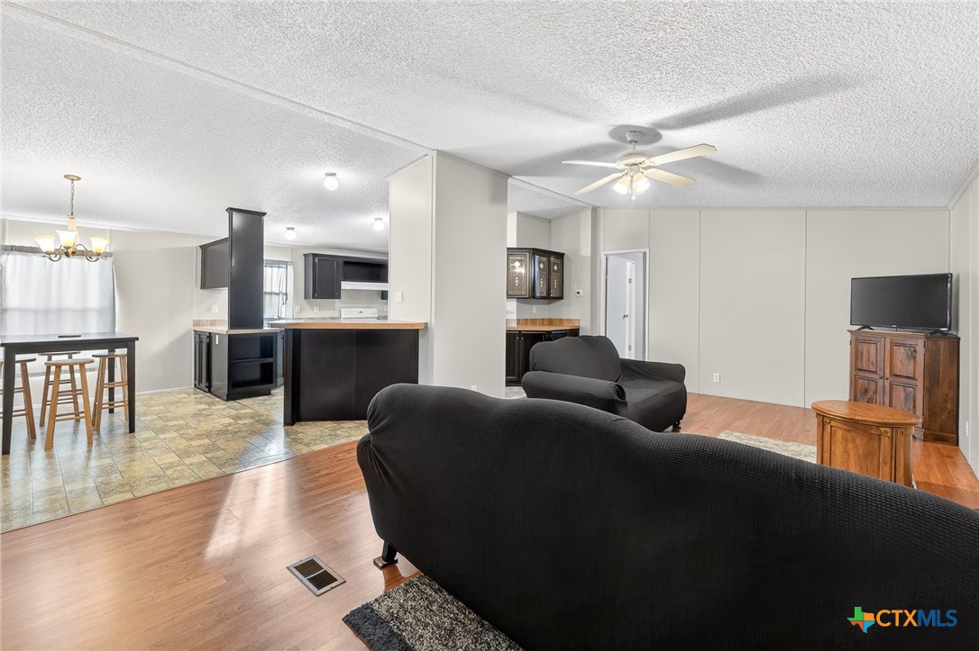 11213 Ridgewood Drive Salado, TX 76571 - Photo 5 of 24 a living room with furniture and a kitchen view