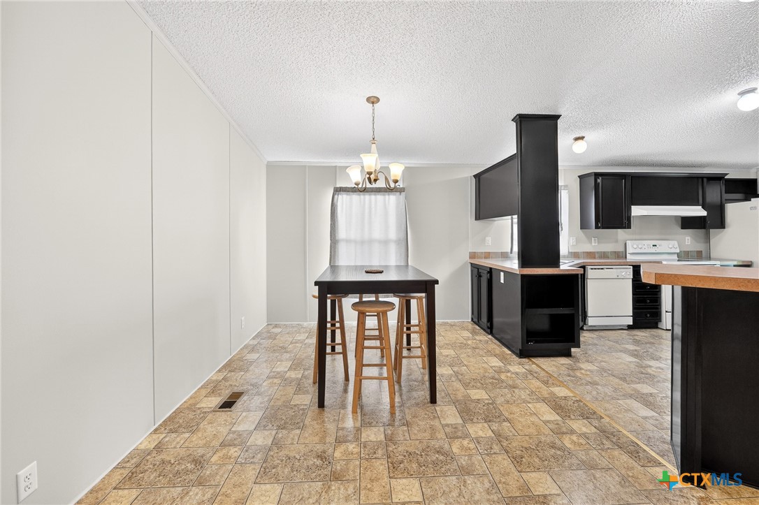 11213 Ridgewood Drive Salado, TX 76571 - Photo 7 of 24 a living room with furniture a fireplace and a flat screen tv