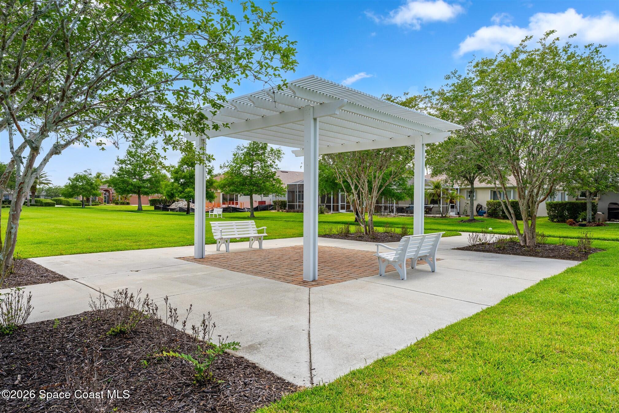 6904 Renshaw Drive Melbourne, FL 32940 - Photo 33 of 46 a view of a patio with a table and chairs under an umbrella