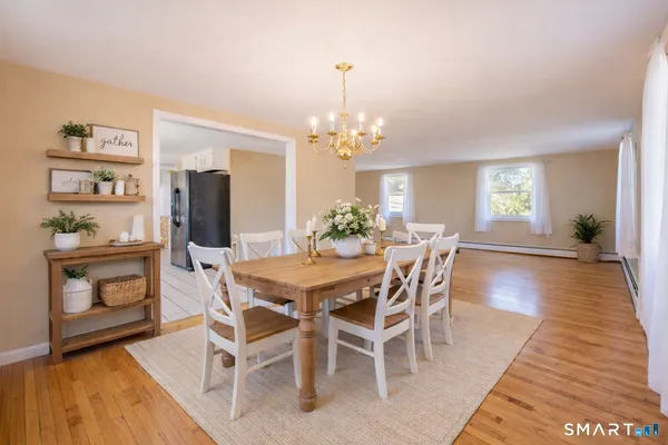 a view of a dining room with furniture and wooden floor