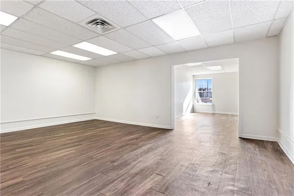 a view of an empty room with wooden floor