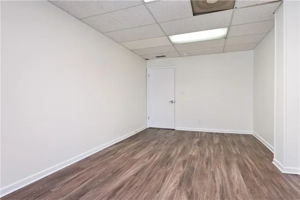 a view of a room with wooden floor