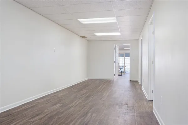 a view of a hallway with wooden floor