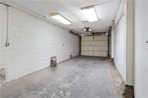 a close view of a utility room with multiple dryer and washer