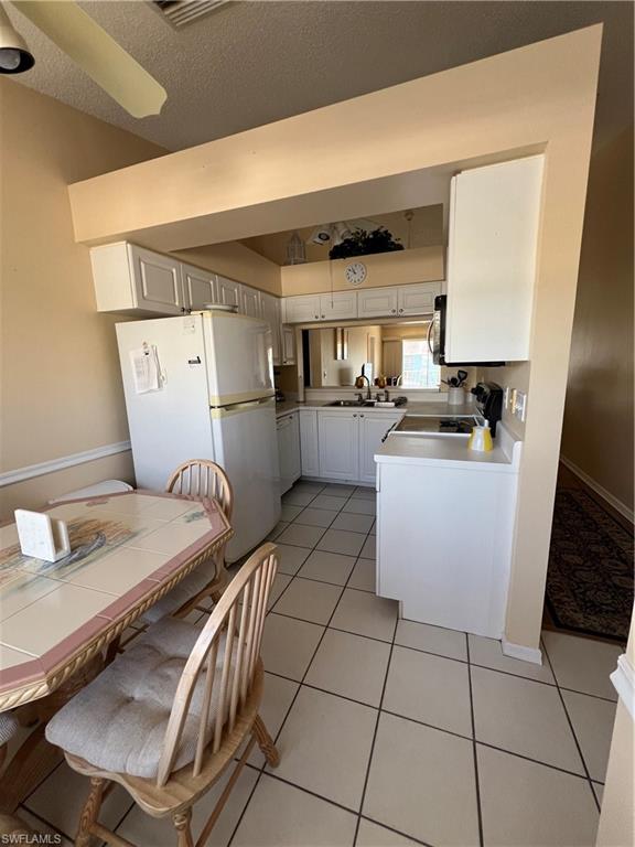 185 Grand Oaks Way, Unit R204 Naples, FL 34110 - Photo 18 of 18 a kitchen with sink cabinets and window