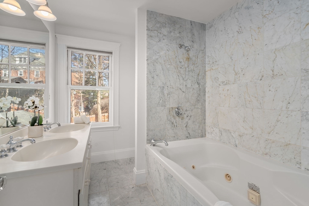 65 Bothfeld Road Newton, MA 02459 - Photo 24 of 31 a bathroom with a tub sink and mirror