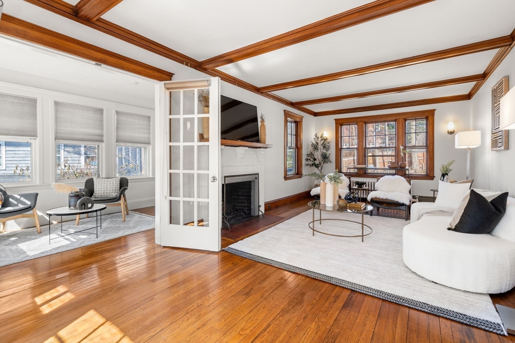 65 Bothfeld Road Newton, MA 02459 - Photo 4 of 31 a living room with furniture a fireplace and a floor to ceiling window