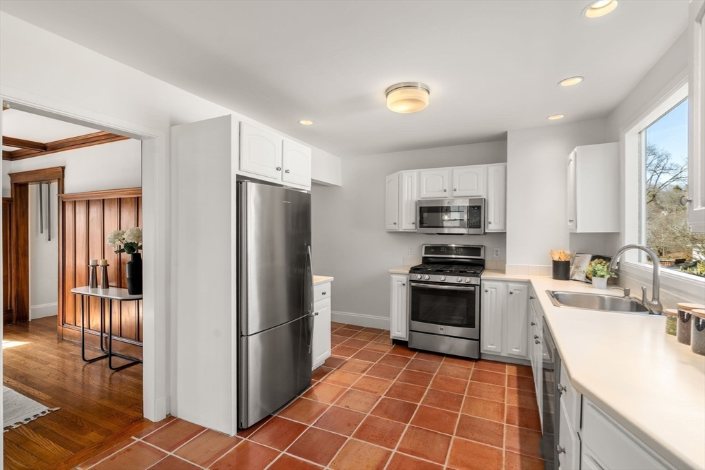 65 Bothfeld Road Newton, MA 02459 - Photo 9 of 31 a kitchen with granite countertop a refrigerator and a stove top oven