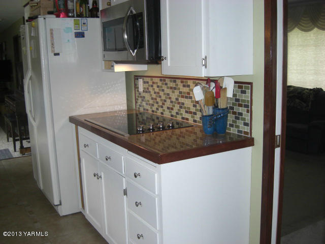 13907 Fisk Road Yakima, WA 98908 - Photo 6 of 55 a kitchen with granite countertop a sink and cabinets