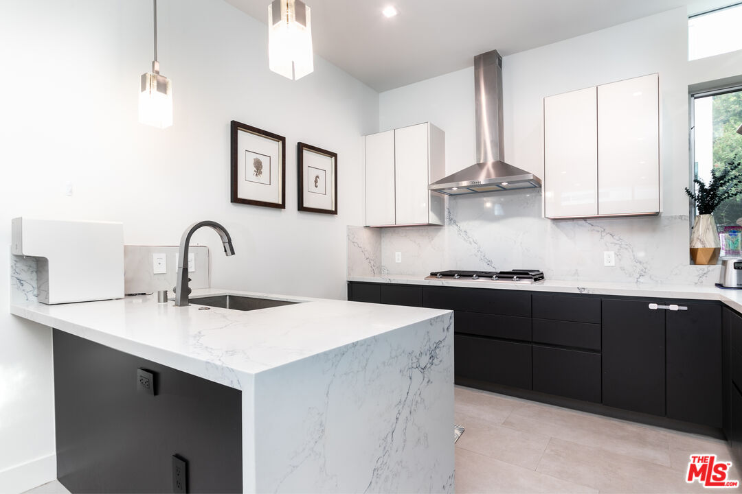 1951 Manning Avenue Los Angeles, CA 90025 - Photo 4 of 27 a kitchen with sink a microwave and cabinets
