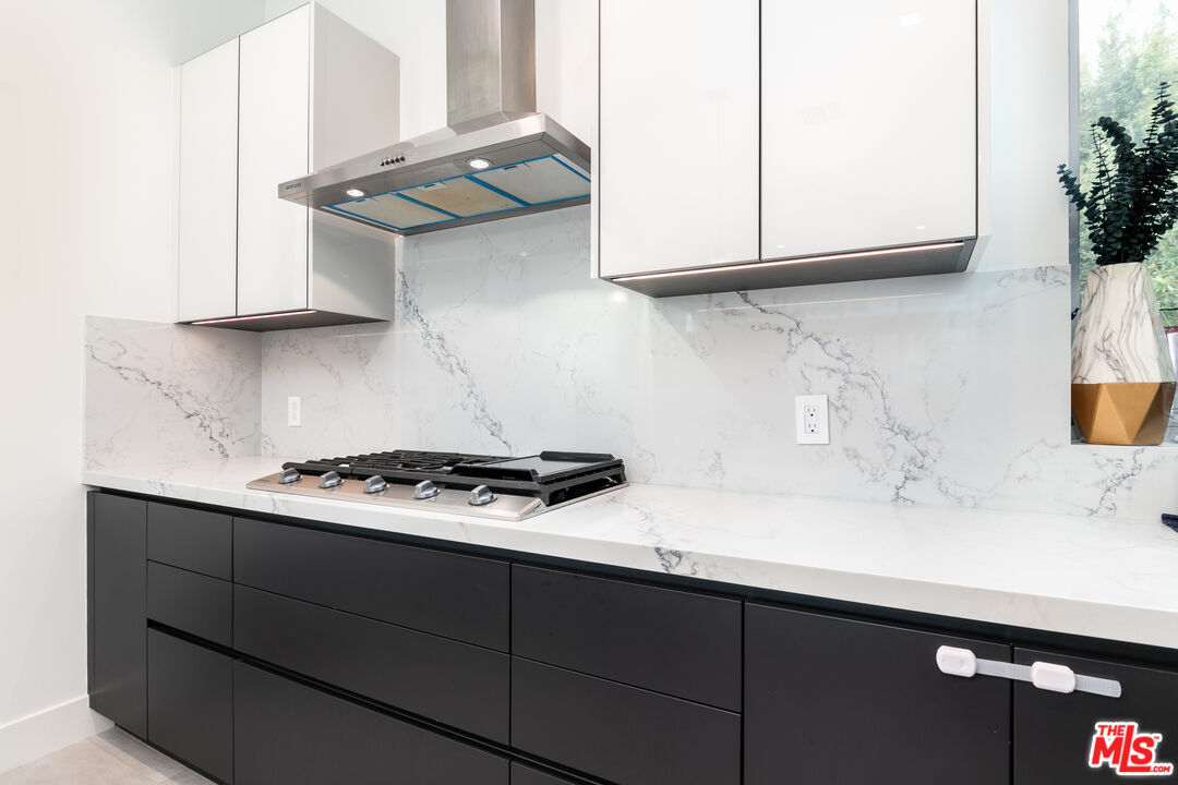 1951 Manning Avenue Los Angeles, CA 90025 - Photo 5 of 27 a kitchen with stainless steel appliances a sink and cabinets
