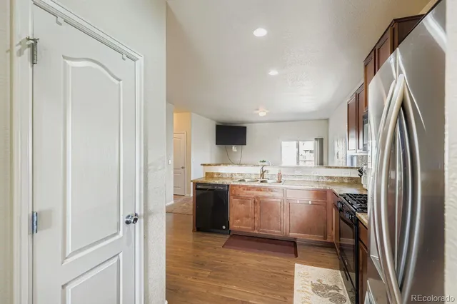 a kitchen with stainless steel appliances granite countertop a refrigerator and a stove