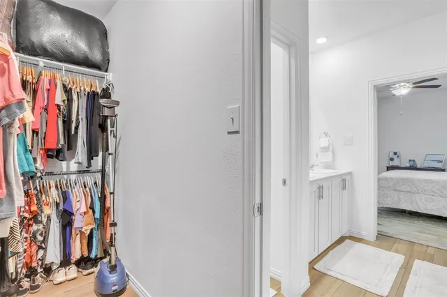 a view of walk in closet with clothes and shoes