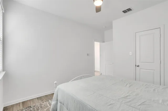 a bedroom with a bed and a white cabinet