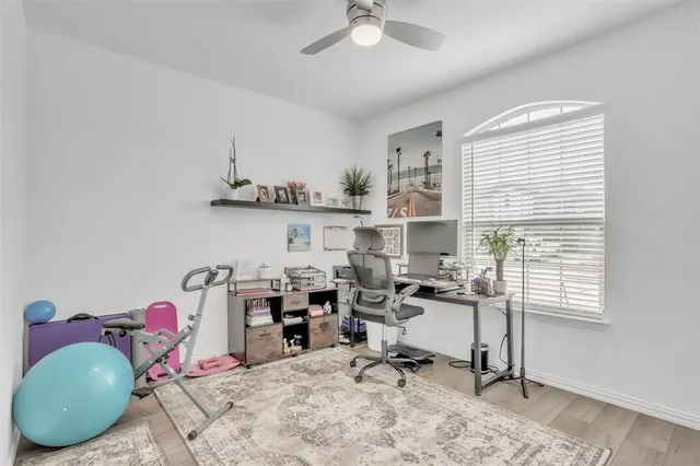a view of a workspace with furniture and a window