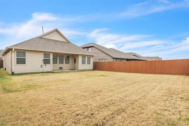 a front view of a house with yard and mountain view in back