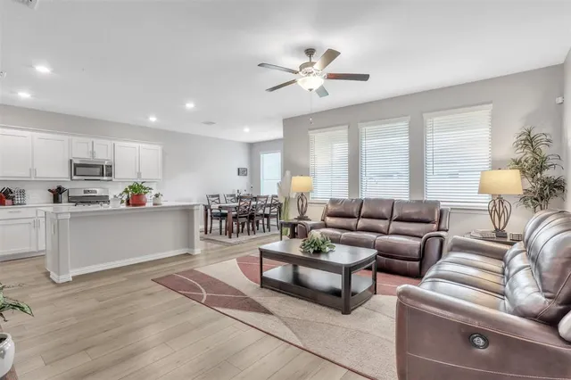 a living room with furniture and kitchen view