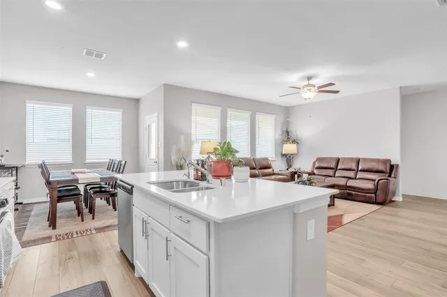 a kitchen with sink and view of living room