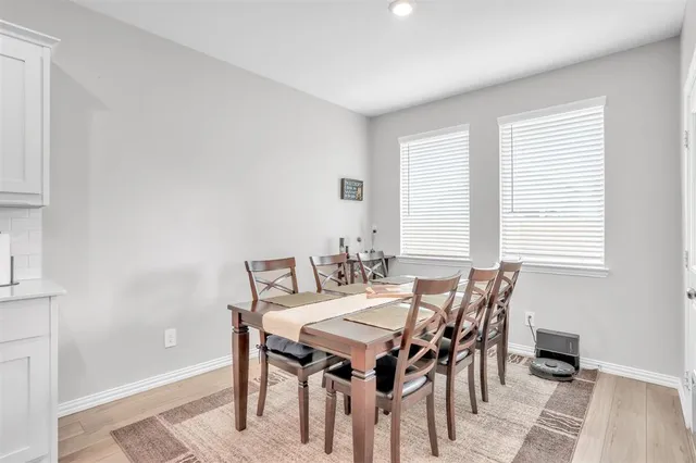 a view of a dining room with furniture and window