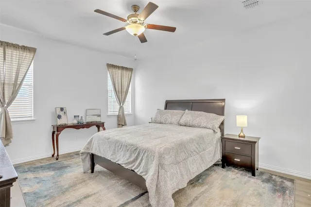 a bedroom with a bed and a chandelier