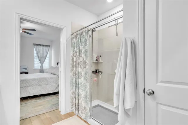 a en suite bathroom with a shower and a sink
