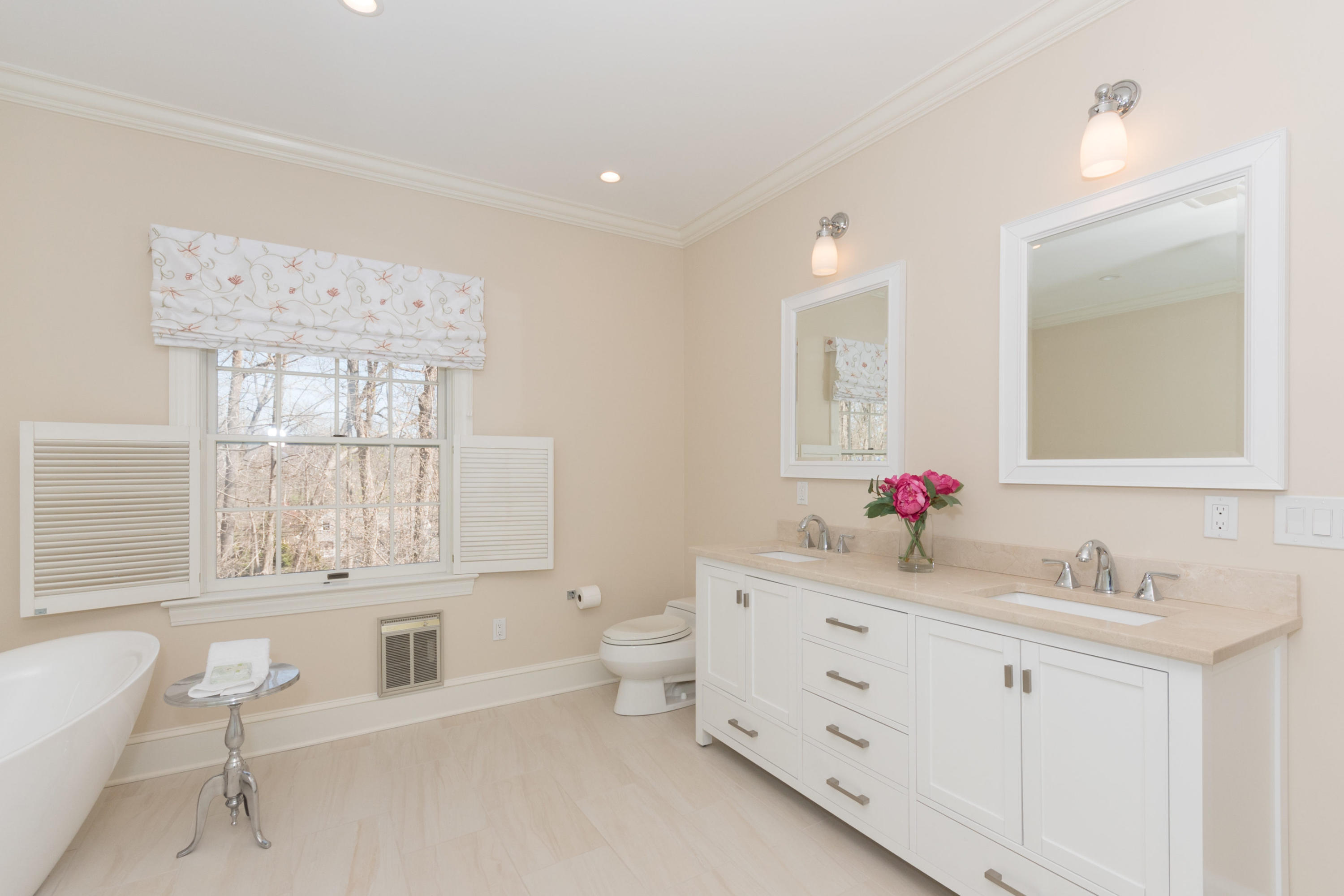 123 Lone Tree Farm Road New Canaan, CT 06840 - Photo 17 of 26 a spacious bathroom with a double vanity sink toilet mirror and bathtub