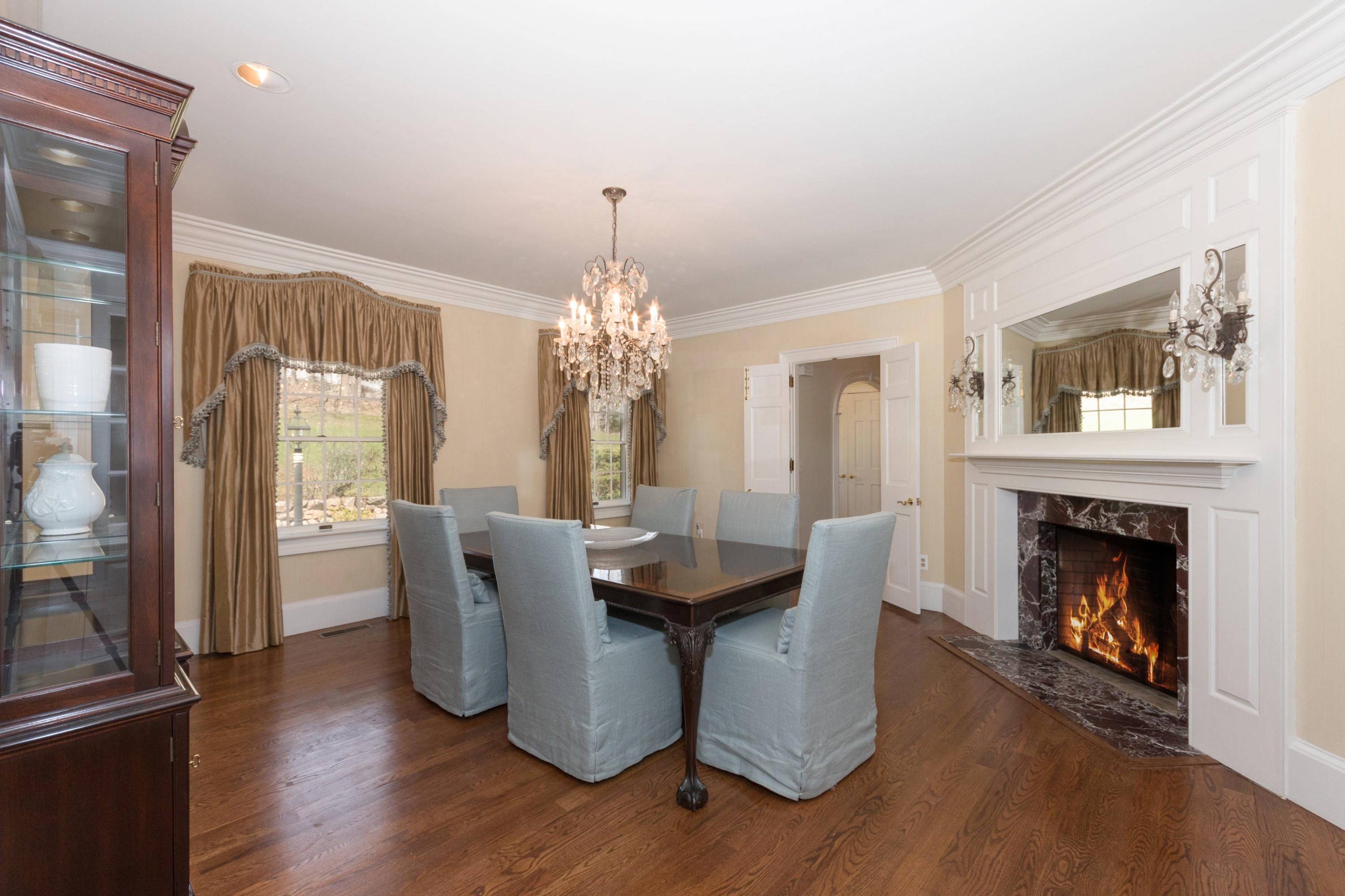 123 Lone Tree Farm Road New Canaan, CT 06840 - Photo 7 of 26 a dining room with furniture wooden floor fireplace and a chandelier
