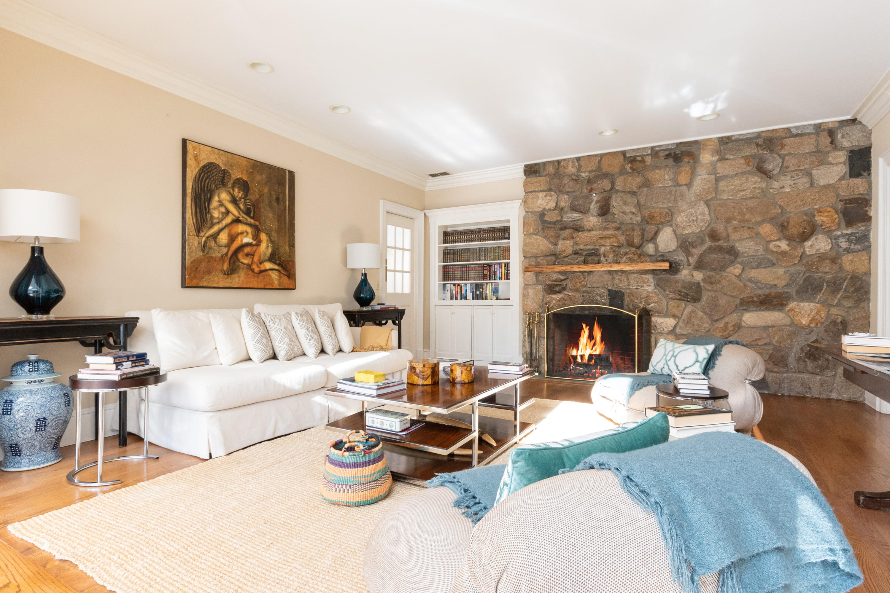 123 Lone Tree Farm Road New Canaan, CT 06840 - Photo 9 of 26 a living room with furniture a fireplace and a flat screen tv