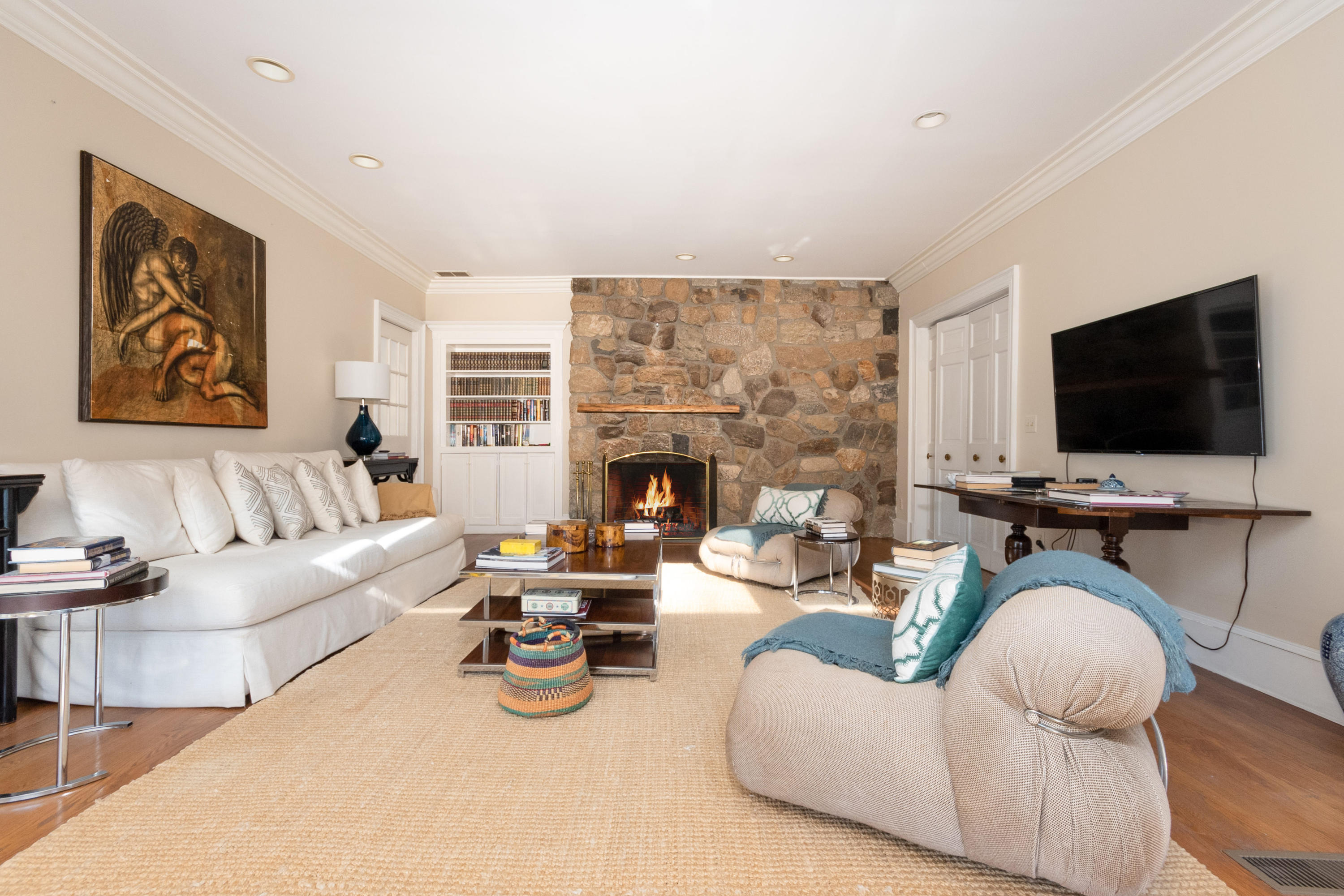 123 Lone Tree Farm Road New Canaan, CT 06840 - Photo 10 of 26 a living room with fireplace furniture and a flat screen tv