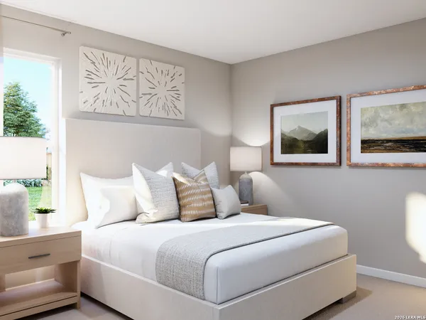 a bedroom with a large bed and a painting on the wall