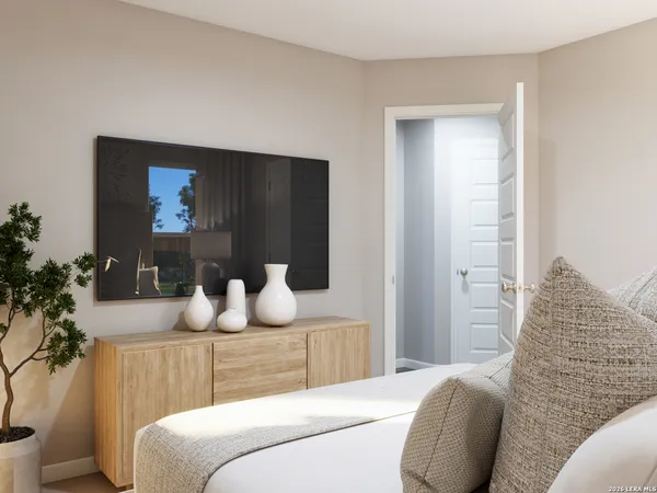 a bedroom with a bed and a potted plant