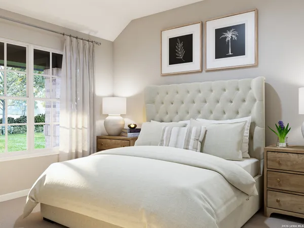 a bedroom with a large bed and a window
