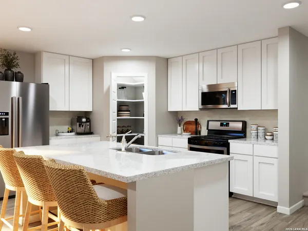 a kitchen with stainless steel appliances a stove a sink a microwave a refrigerator and cabinets