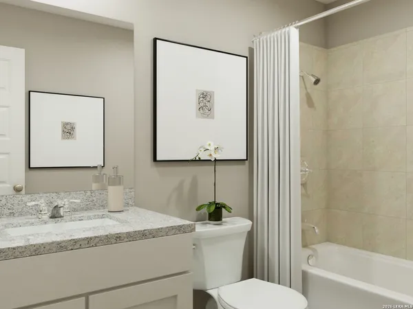 a bathroom with a granite countertop sink mirror vanity and toilet