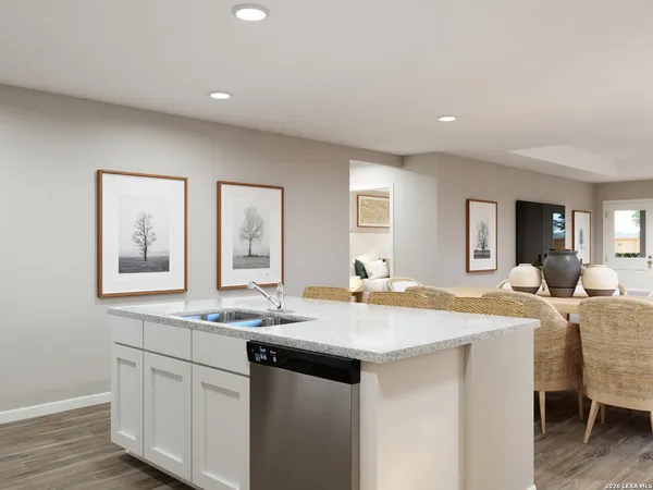 a dining hall with stainless steel appliances granite countertop a sink and dishwasher with wooden floor