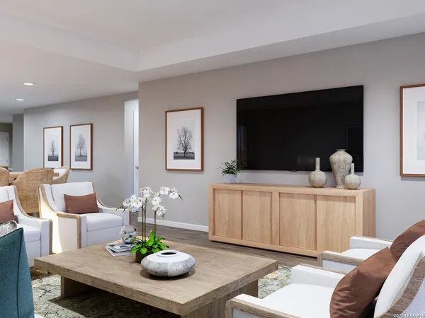 a living room with furniture a flat screen tv and a window