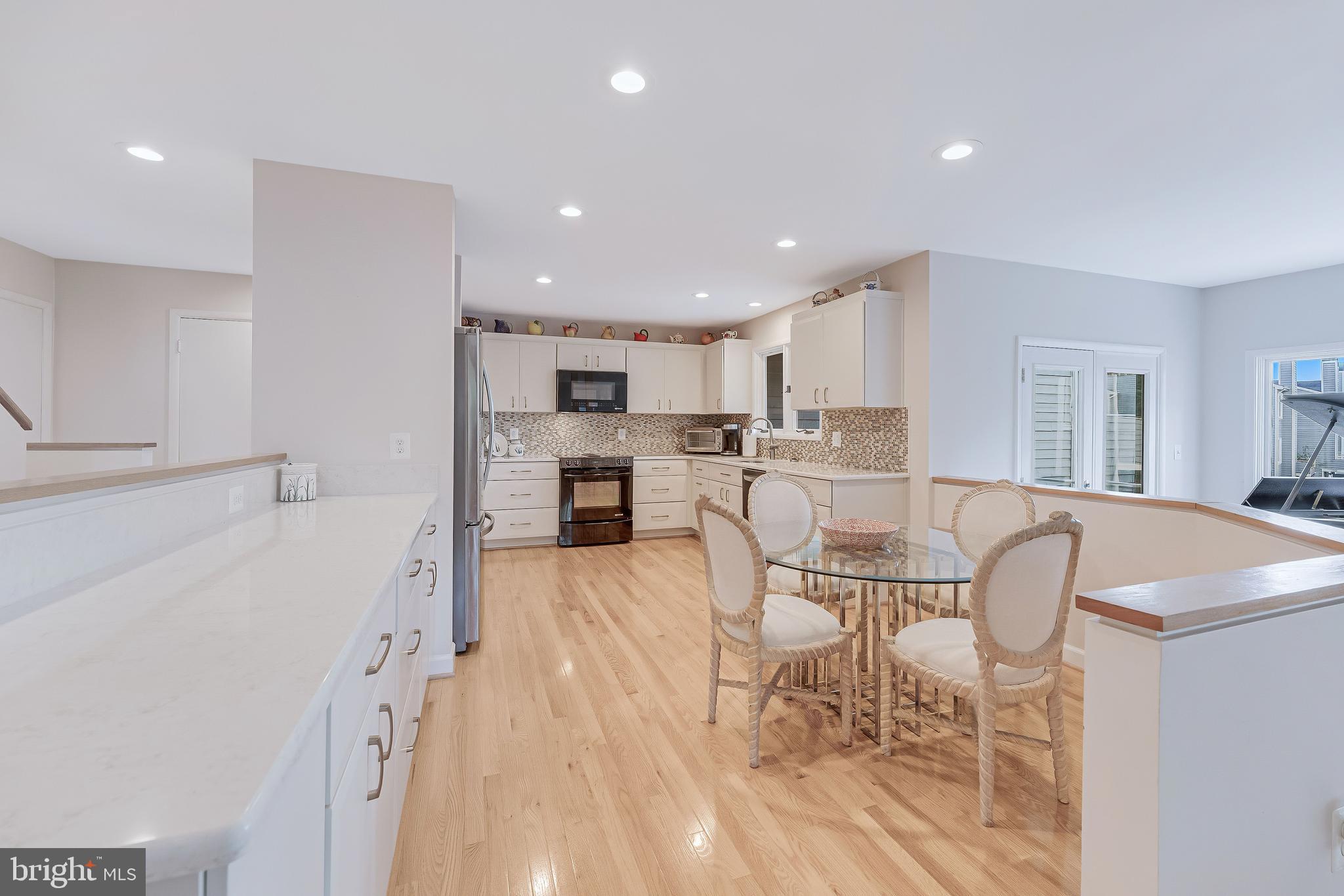 1933 Lakeport Way Reston, VA 20191 - Photo 13 of 57 a living room with furniture and a dining table with kitchen view