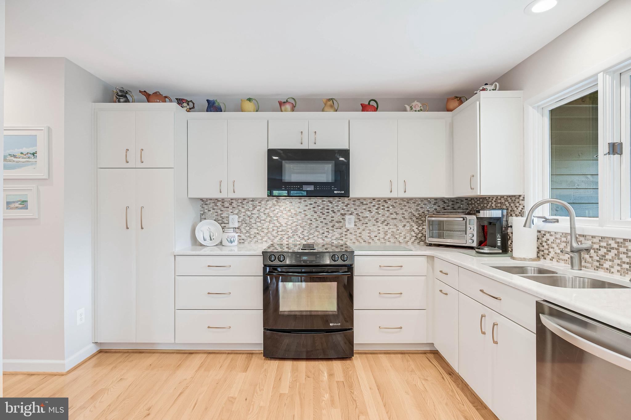1933 Lakeport Way Reston, VA 20191 - Photo 17 of 57 a kitchen with granite countertop white cabinets and white appliances