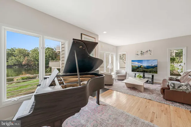 a living room with furniture tv and a large window