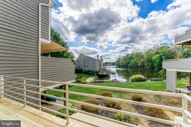 a view of a house with a big yard and a large tree