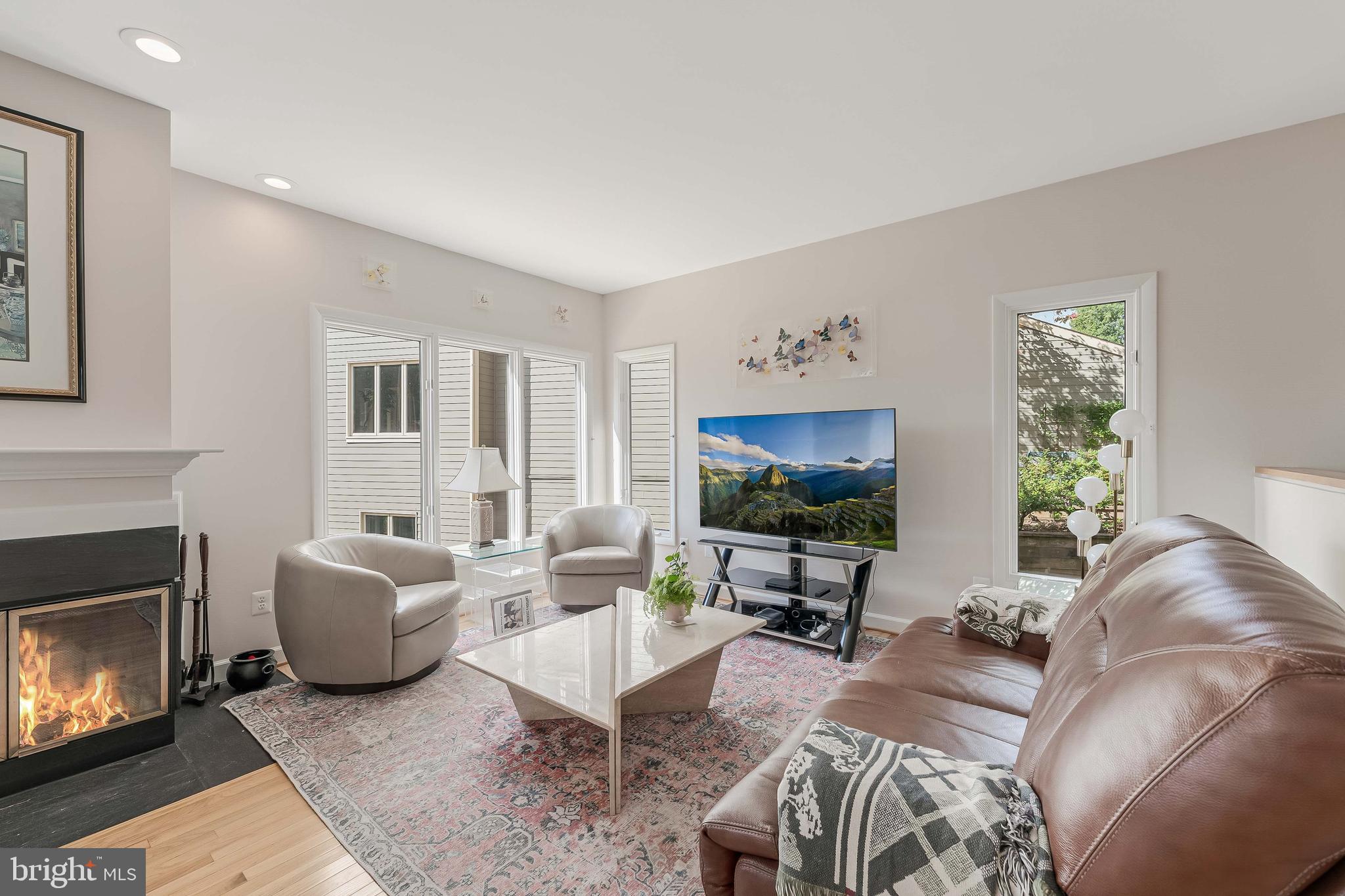 1933 Lakeport Way Reston, VA 20191 - Photo 25 of 57 a living room with furniture a flat screen tv and a fireplace