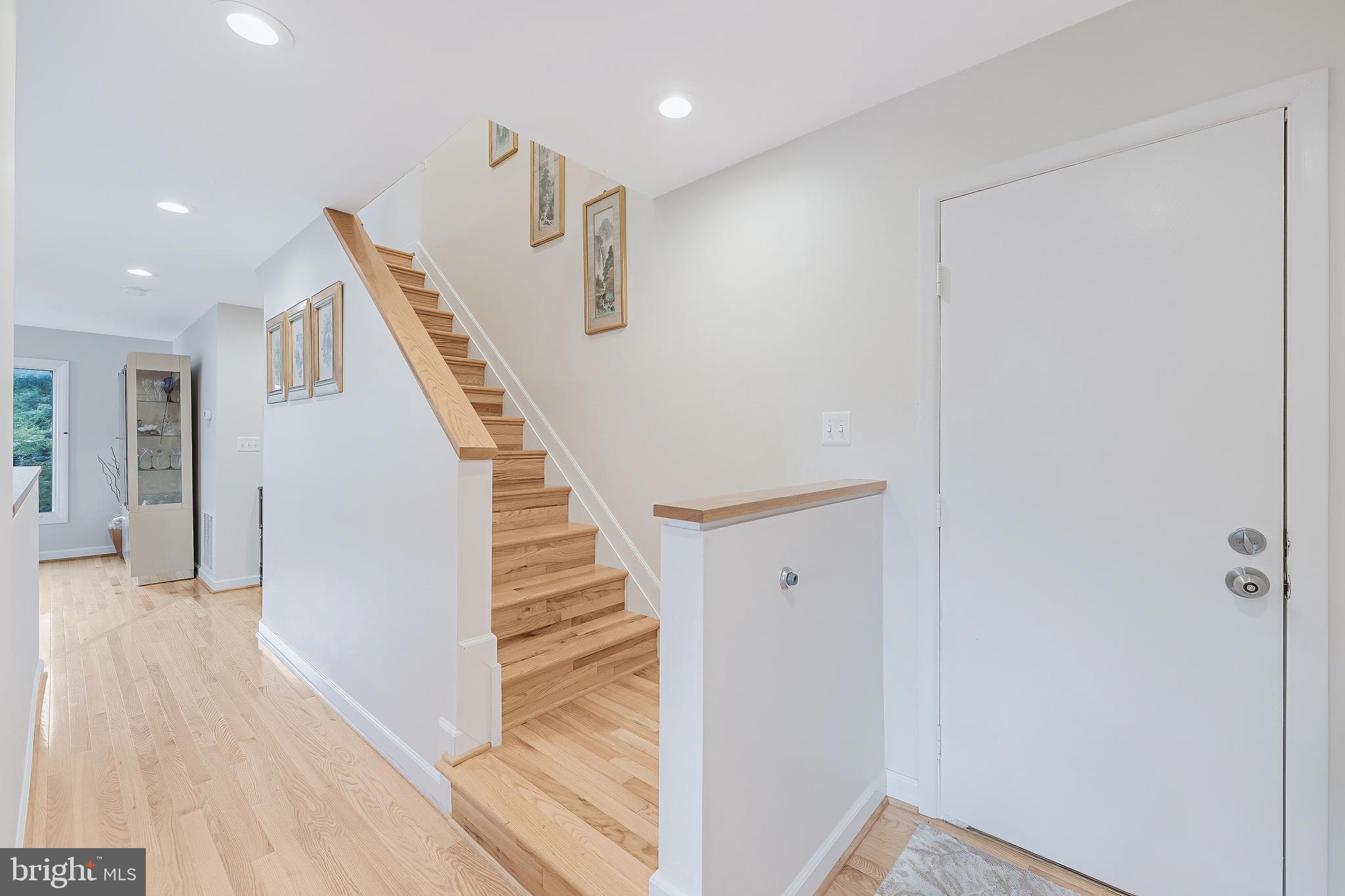 1933 Lakeport Way Reston, VA 20191 - Photo 30 of 57 a view of a hallway with wooden floor and stairs